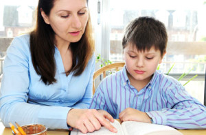 woman tutoring young boy